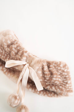 Brown faux fur scarf with a pink ribbon on a light background