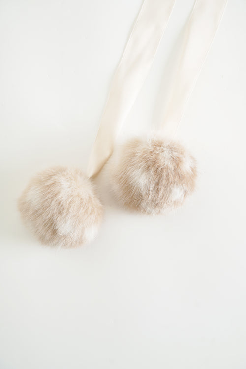 Close-up of a fluffy white dog on a light background