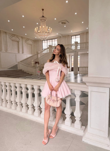Two people lying on a rocky surface with a blue sky background