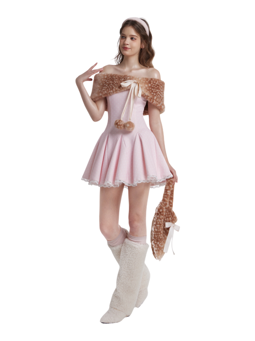 Woman in a pink dress with a deer print shawl and boots on a white background